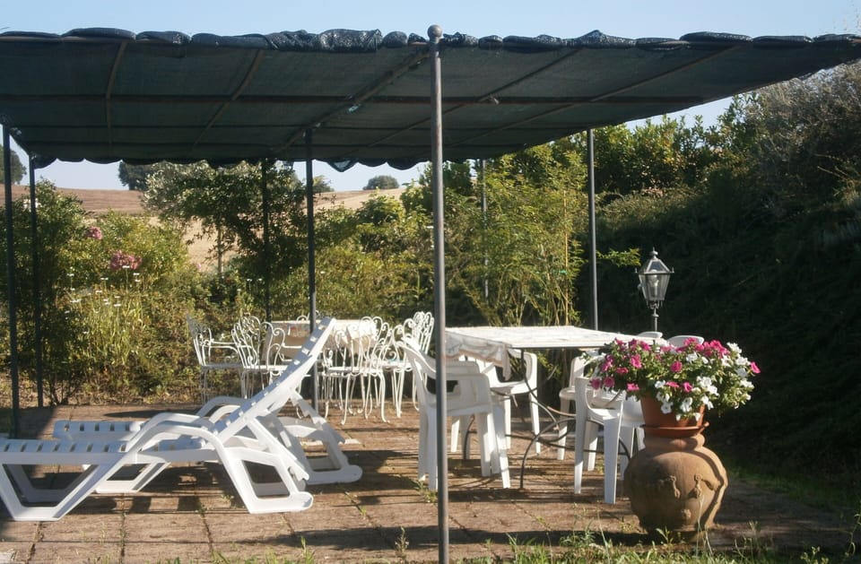 Relax by the pool under the gazebos, with tables, chairs and loungers