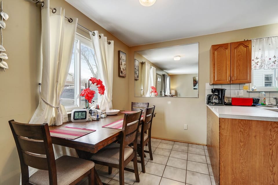 Spacious Dining Room with new dining table, 4 chairs, electric clock and more