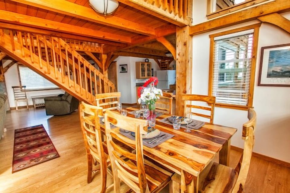 Dining room is adjacent to kitchen; stairs to second floor in background.