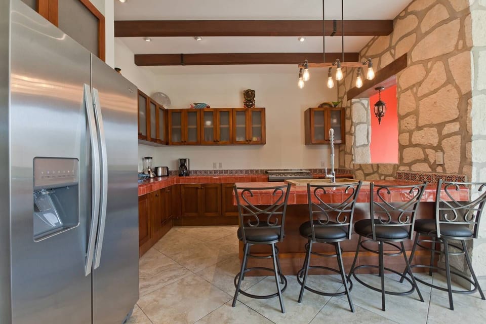 spacious kitchen with breakfast bar open to living area