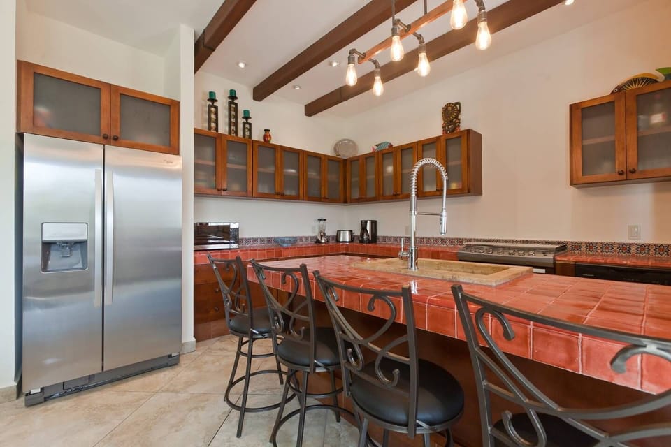Very open and spacious Hacienda style kitchen with full size refrigerator