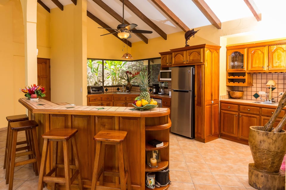 Kitchen with wet bar on right side