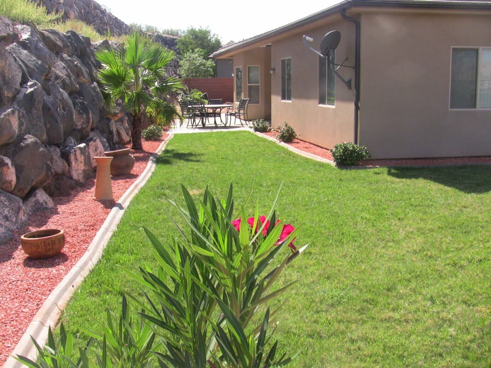 Back Yard, Looking Westward, showing outdoor dining table and chairs