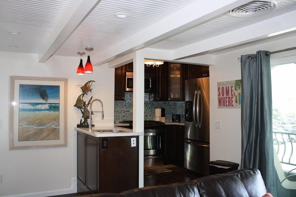 Modern kitchen attached with sink and bar. A little lay back touch here too...