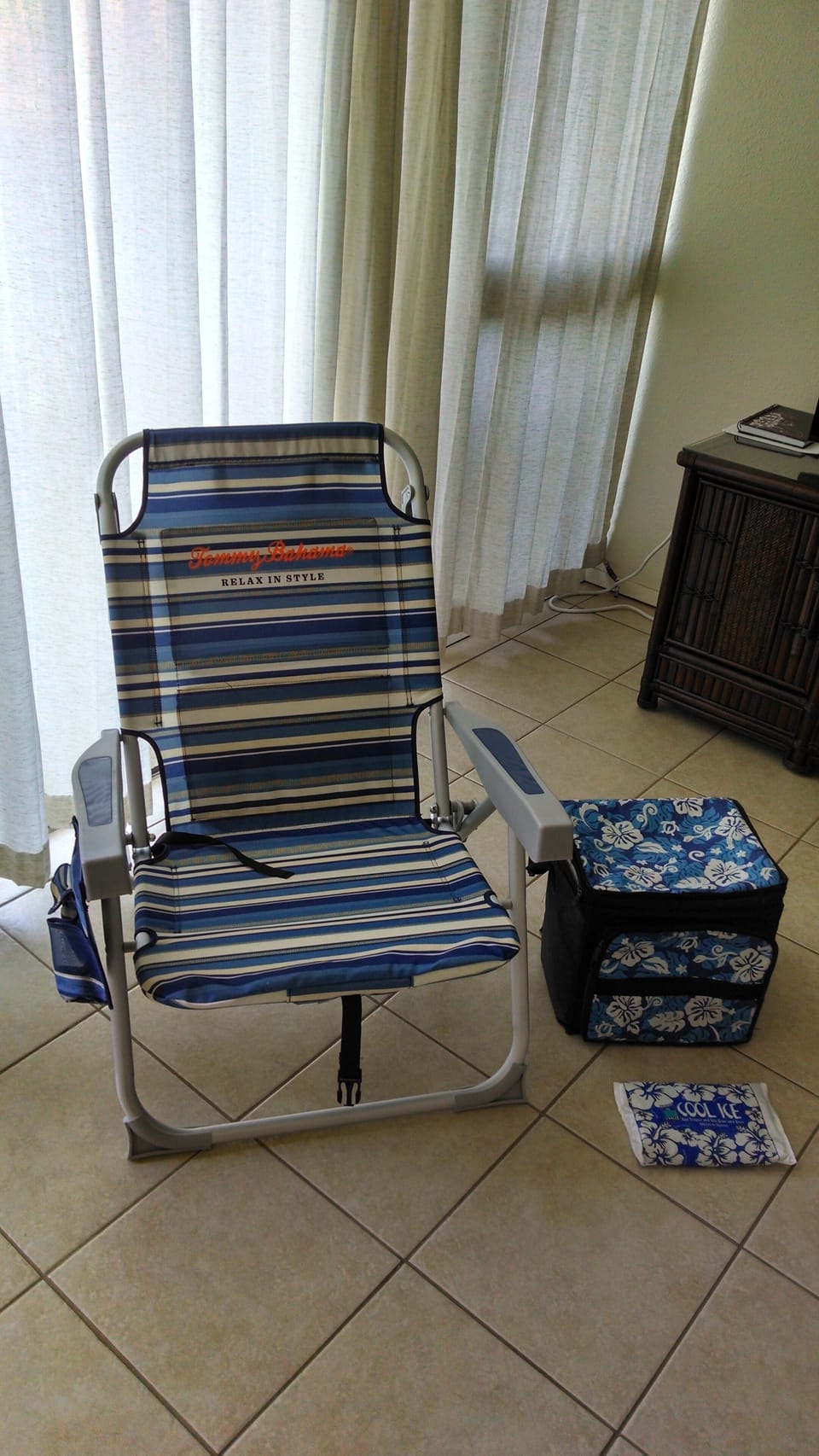 Two Tommy Bahama backpack chairs, a cooler with reusable ice packs, and (not shown) a beach umbrella and two smaller beach chairs for guests. 