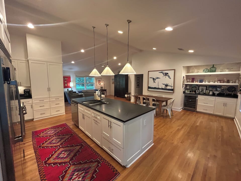 Kitchen, dining, bar, living.  Everything you need in one open concept space.  