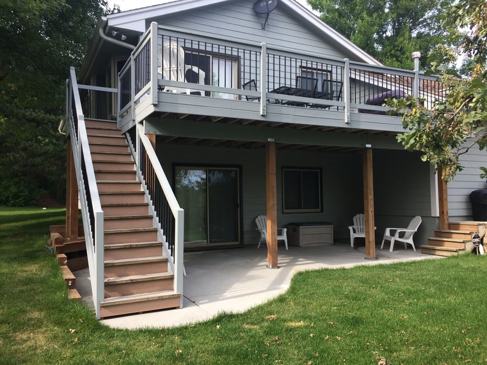 Deck and patio overlooks the vast yard and surrounding wooded acreage.