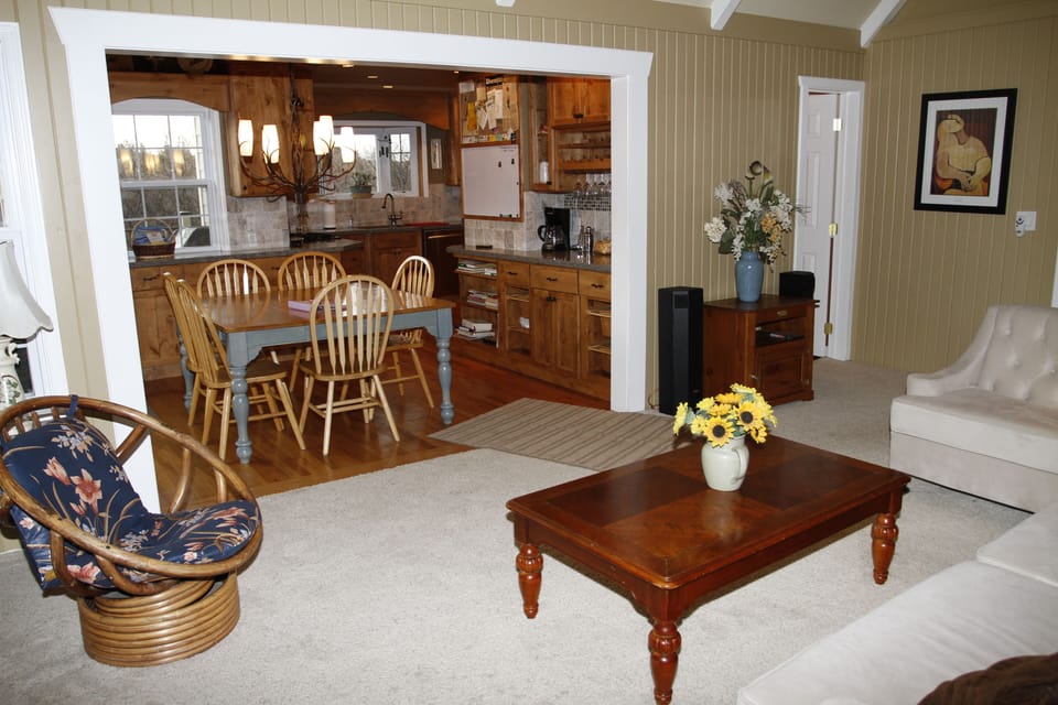 Living Room view toward kitchen dining and powder room.