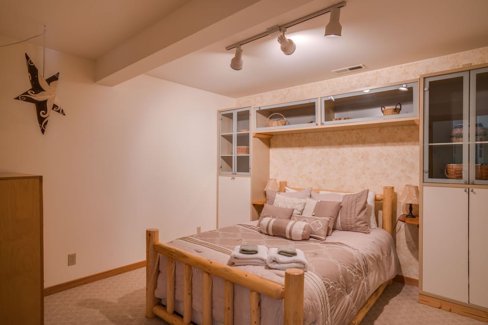 Comfy double bed in the lower level bdrm.  Update: Egress window is in bedroom.