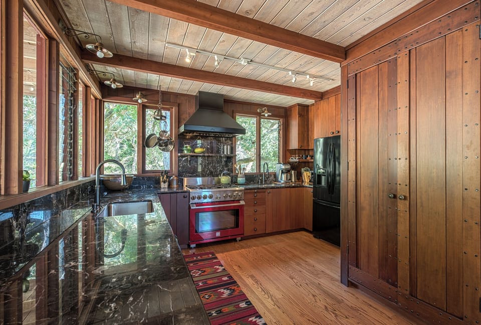 Why eat out? Ample marble countertops, prep sink, dishwasher — and views!.