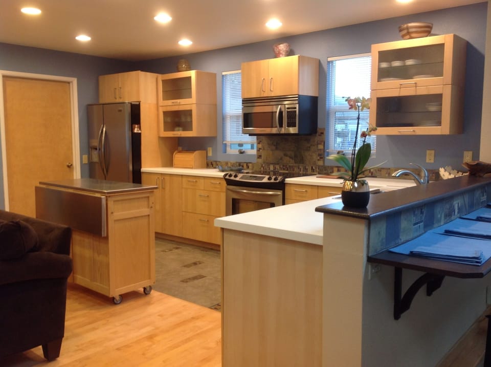 Lots of cabinet space that holds plenty of dishes, utensils and cookware.