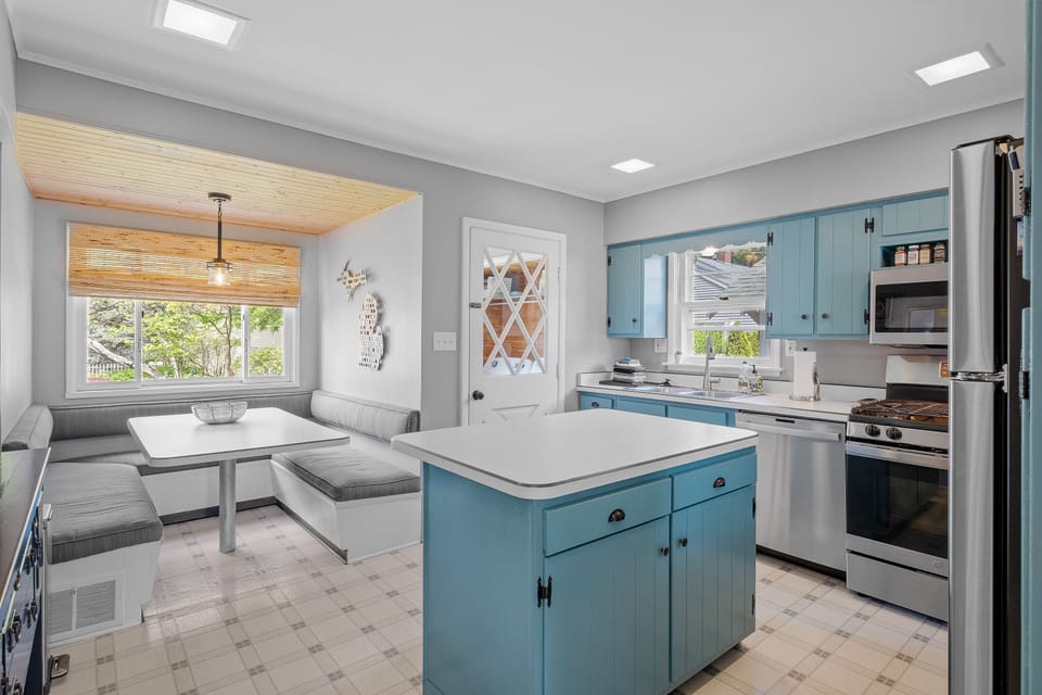 Inviting kitchen with stainless steel appliances, cozy nook, and supplies