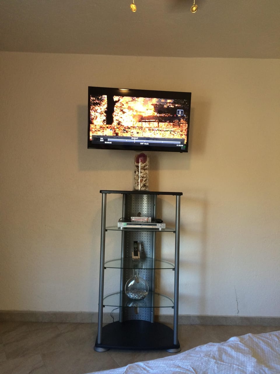 Wall mounted Samsung tv with US Dish programming. 