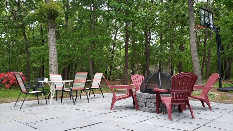 Large back patio with fire-pit and some of the outdoor seating.