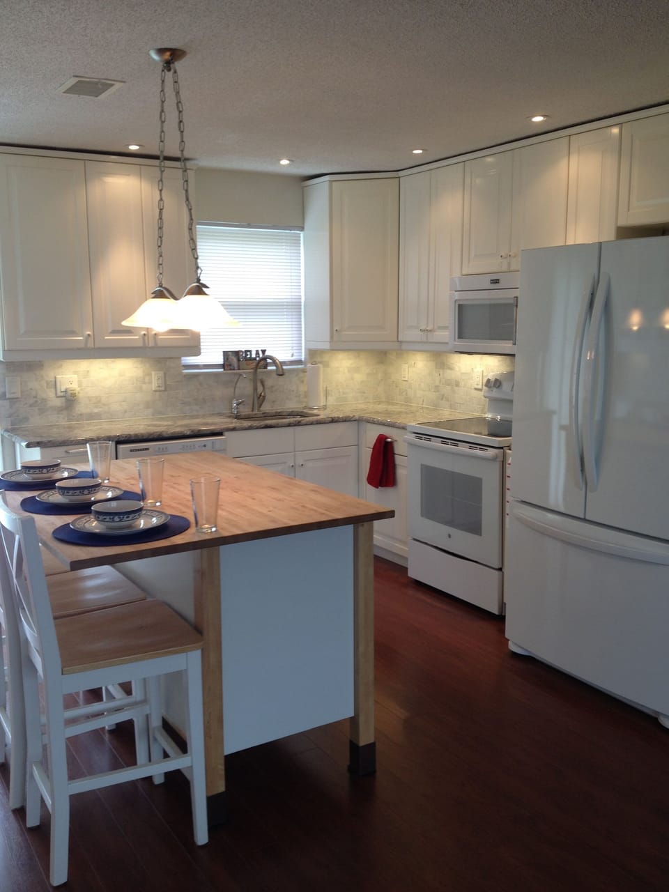Kitchen remodeled with oven microwave and large refrigerator/freezer.