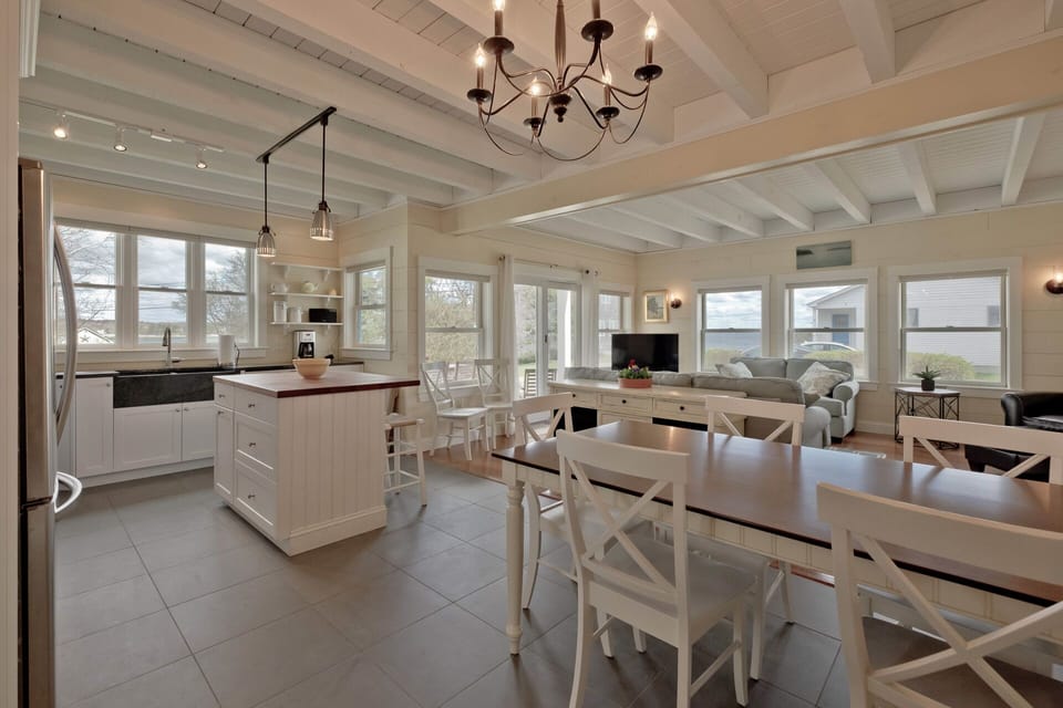 Open-plan kitchen and dining room. The dining room table sits 8-10 people