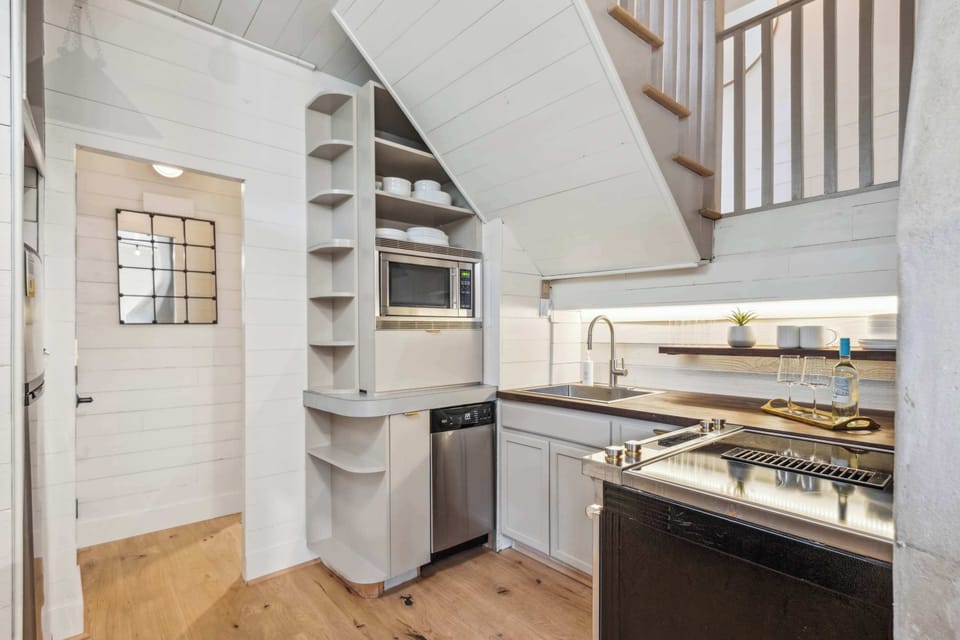 Inviting Kitchenette with Full Size Jenn-Air Range, Dishwasher, Microwave, Full Sized Fridge, Keurig Coffee Maker, and Toaster Oven. 