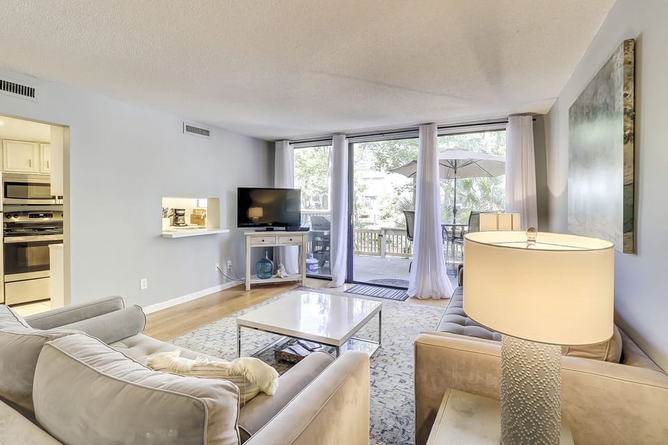 First floor living area opens up to deck with outdoor seating and gas grill. 