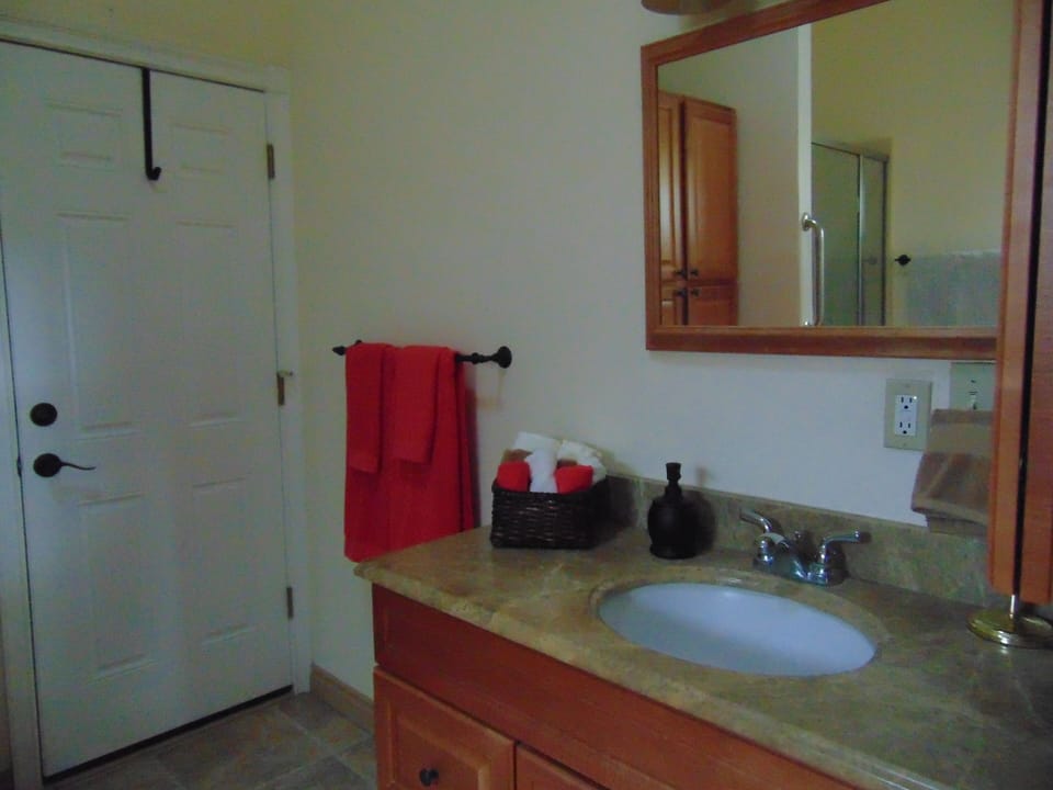 Large bathroom with bath linens, soap, shampoo, hair dryer & other supplies 