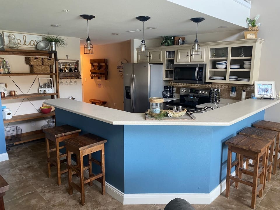 Kitchen with wraparound bar for additional sitting.  