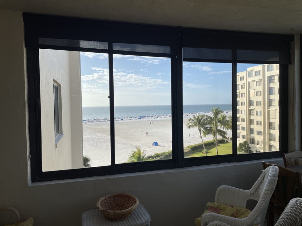 Sun room with beautiful view of beach and sunsets.
