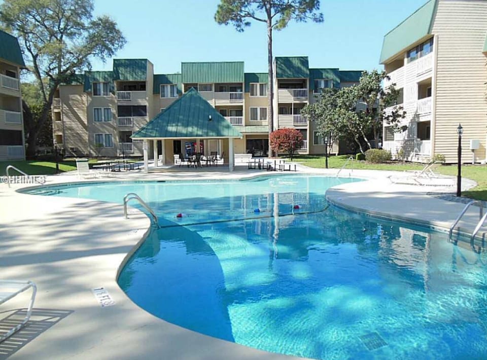 Larger outdoor pool with gazebo,  shuffleboard & grill 