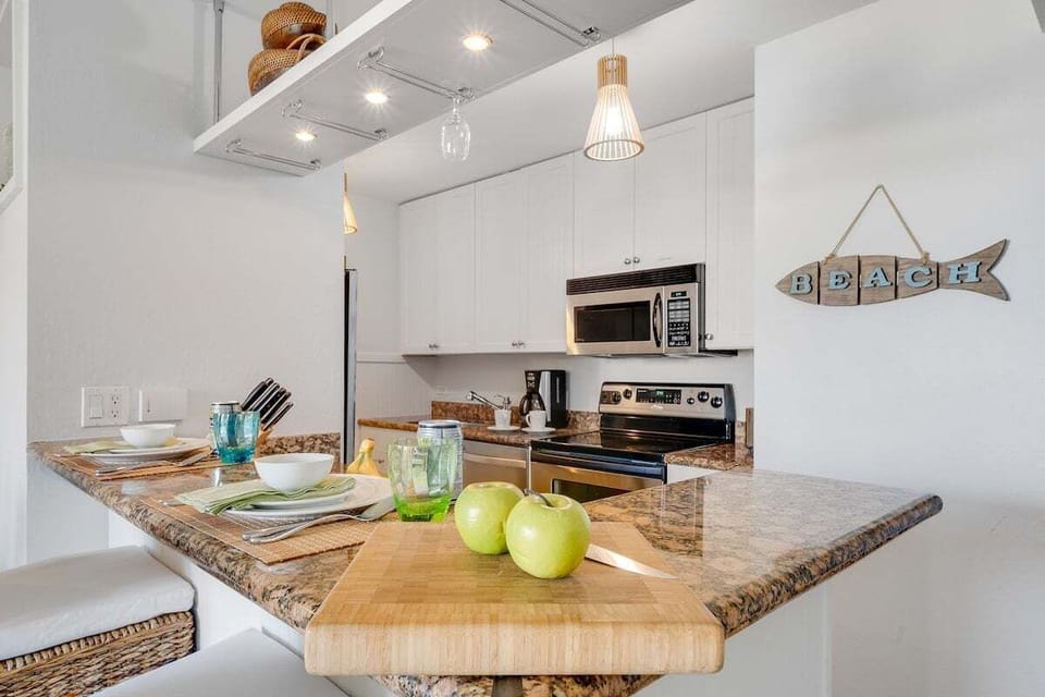 Functional kitchen with stainless steel appliances and white cabinets