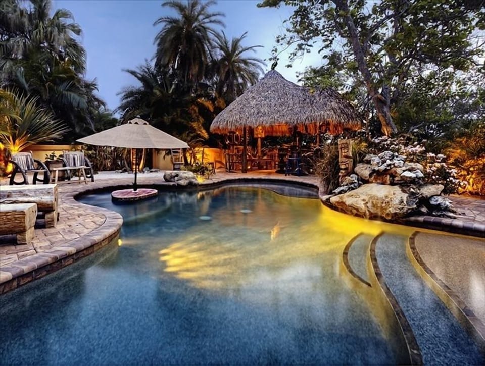 The lagoon pool in the evening.  Beach entry, baja ledge and swim cocktail table