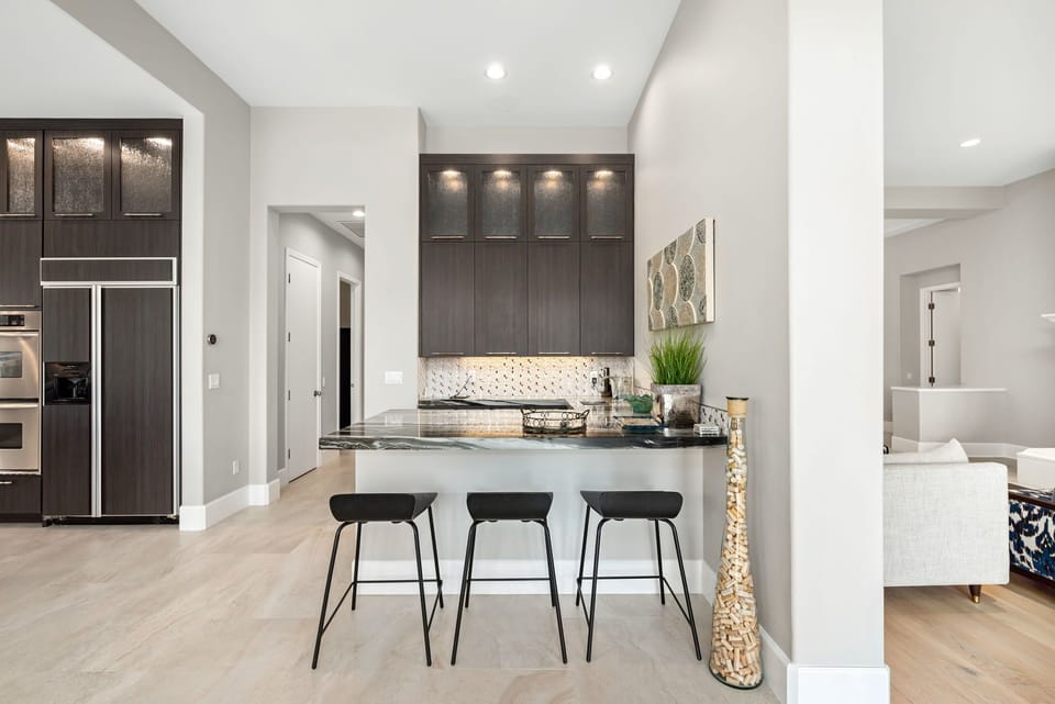 Wet bar with sink, refrigerator and barware with separate seating