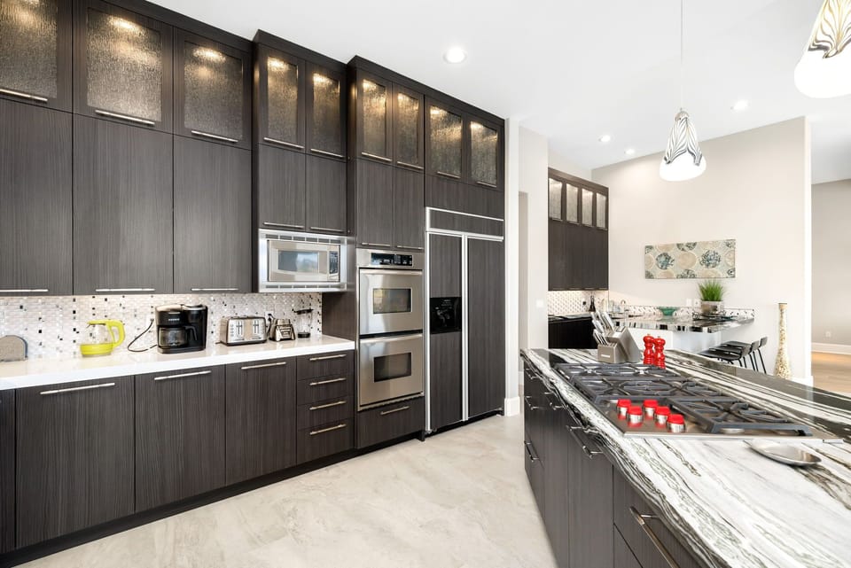 Enjoy a gourmet kitchen! Wolf cooktop, modern appliances, full array of cookware