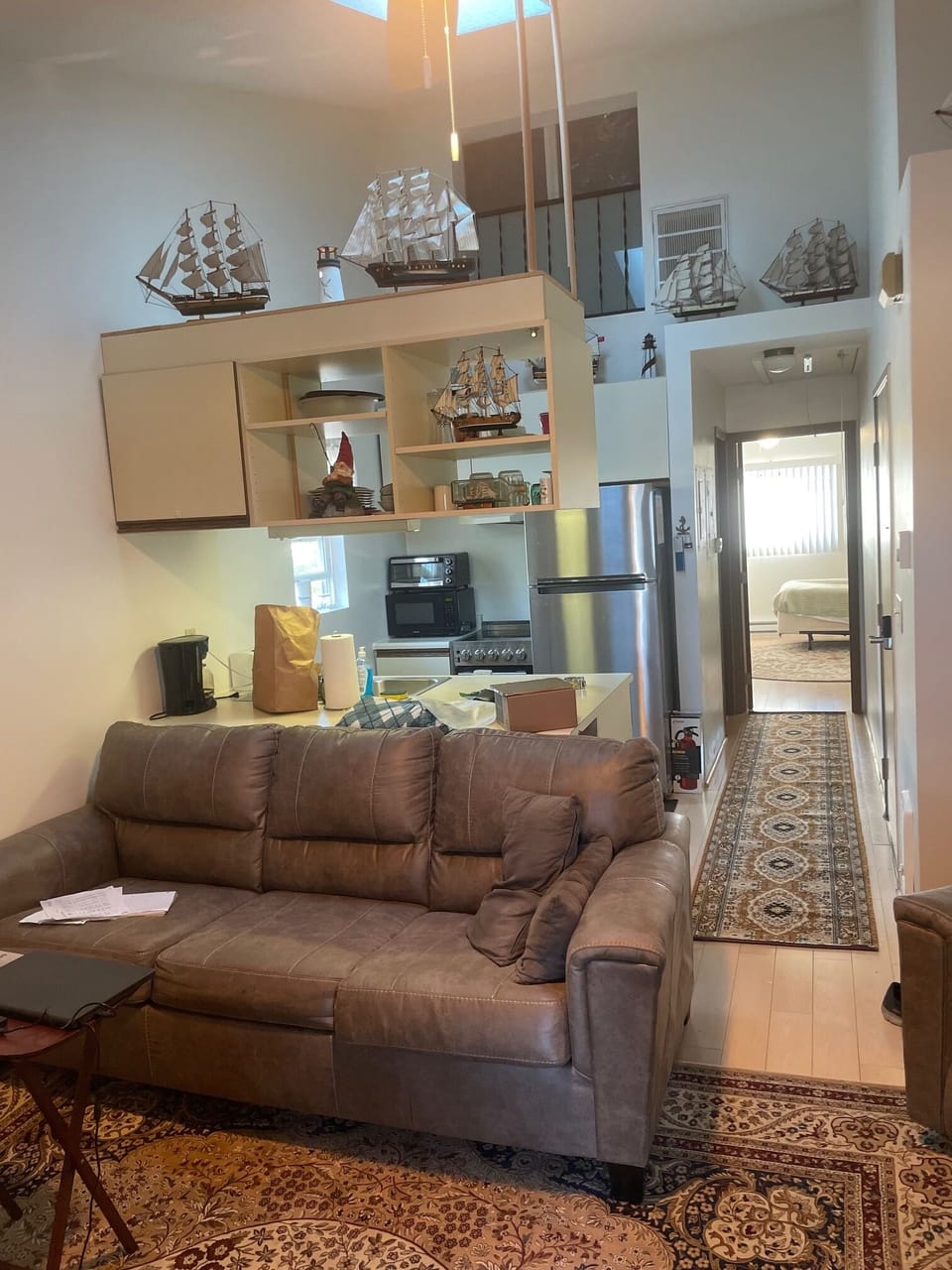 View of living room, kitchen and hallway leading to the bedroom