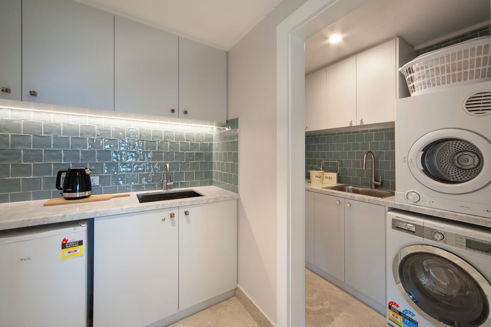 Downstairs kitchenette- fridge.
Bosch washer, Dryer, laundry