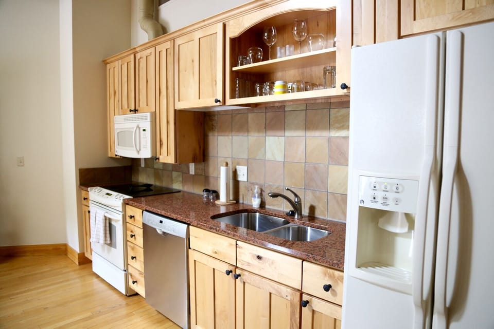 Open kitchen with granite counter tops.