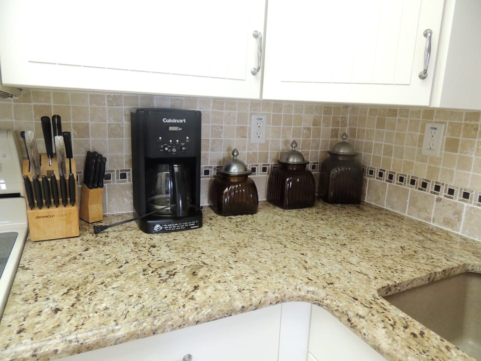 Picture of some of the appliances in fully stocked kitchen 
