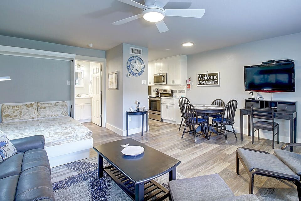 Relax in your thoughtfully designed open-concept space with modern kitchen, cozy dining area, and entertainment center.