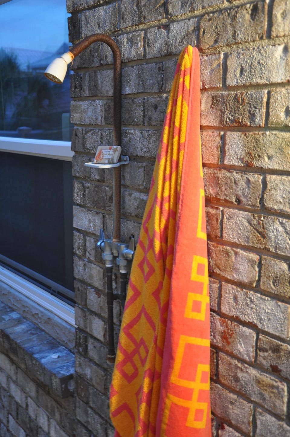 Outdoor beach shower on side of house
