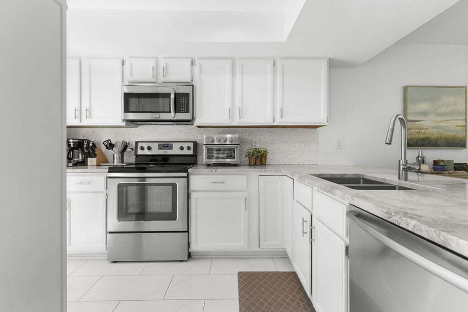 The kitchen is fresh and welcoming, thoughtfully stocked with everything needed to prepare a meal comfortably.