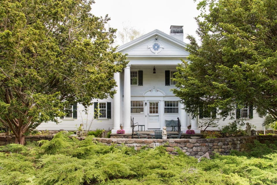Eight gracious Ionic columns front our 1790 historic  Sea Captain's Estate 