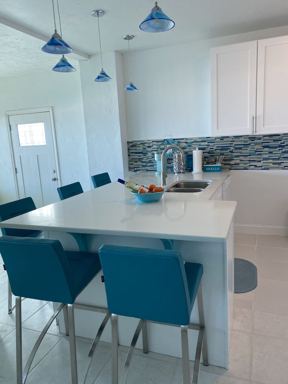 Large spacious kitchen with barstools with adjoining kitchen table