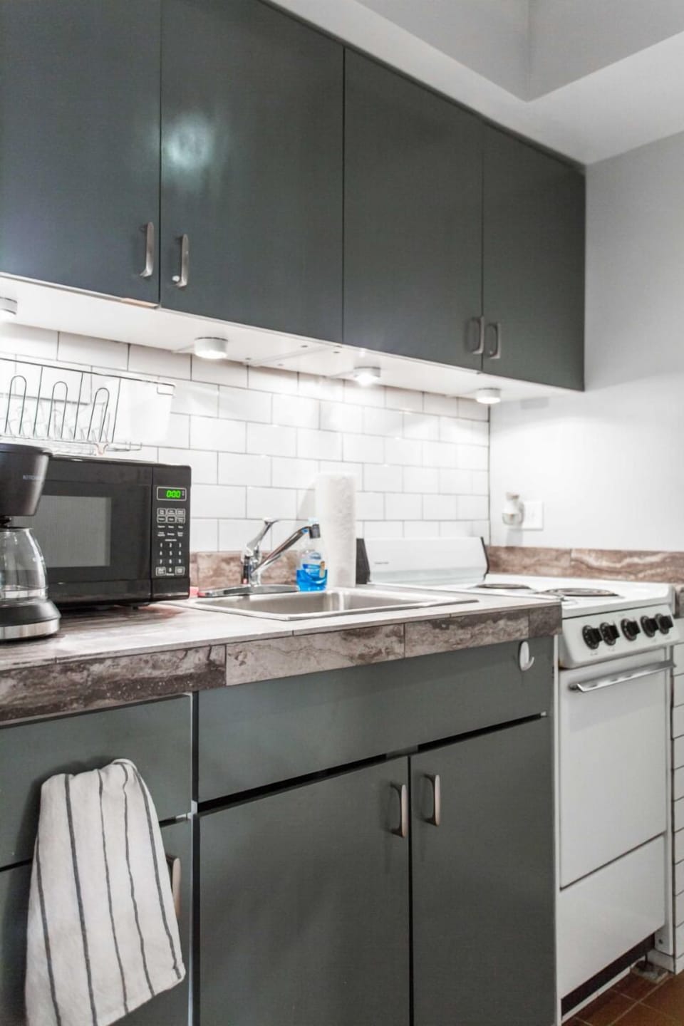 Stove with oven, microwave, coffee machine, tea kettle are thoughtfully laid out