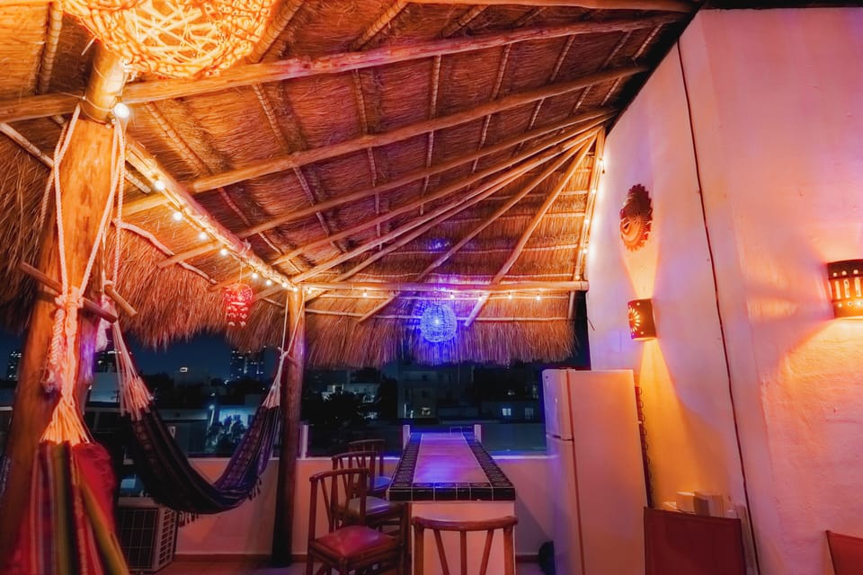 Handcrafted palapa w/artisan bar, ceramics, benches, colorful globes & hammocks.