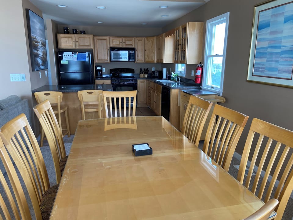 Modern open kitchen / dining room with seating for 14.