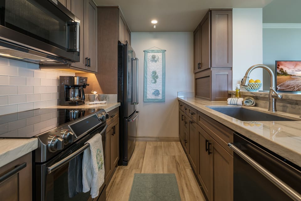 Kitchen Area With All New Cabinetry And Marble Counters