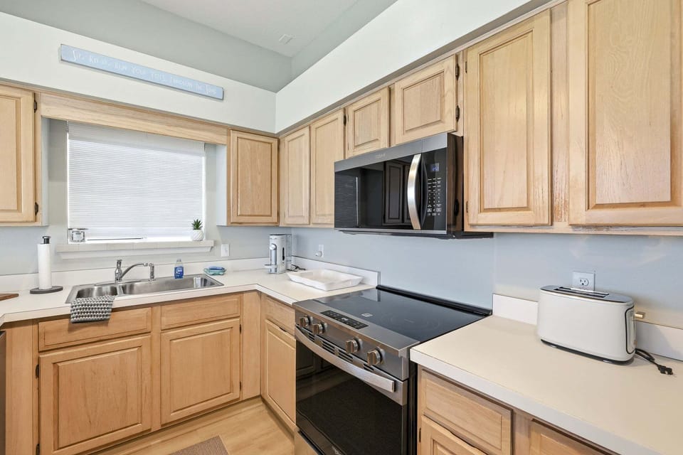 Prepare meals with ease in this spacious kitchen featuring modern appliances, ample counter space, and everything you need for your stay