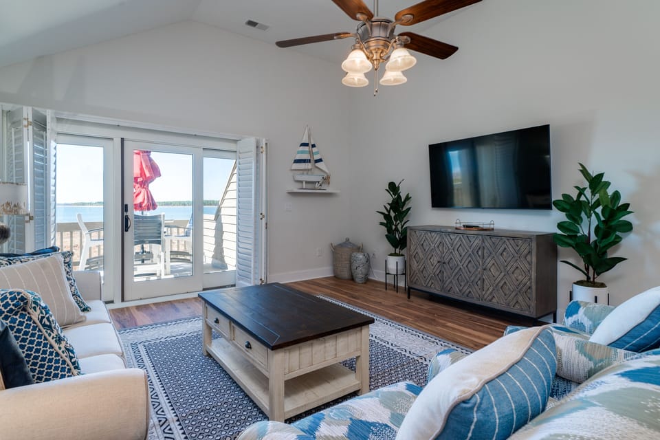 This villa has plenty of natural sunlight. Sliders lead out to the rear deck with spectacular views of the water and the beach. Steps away from the beach