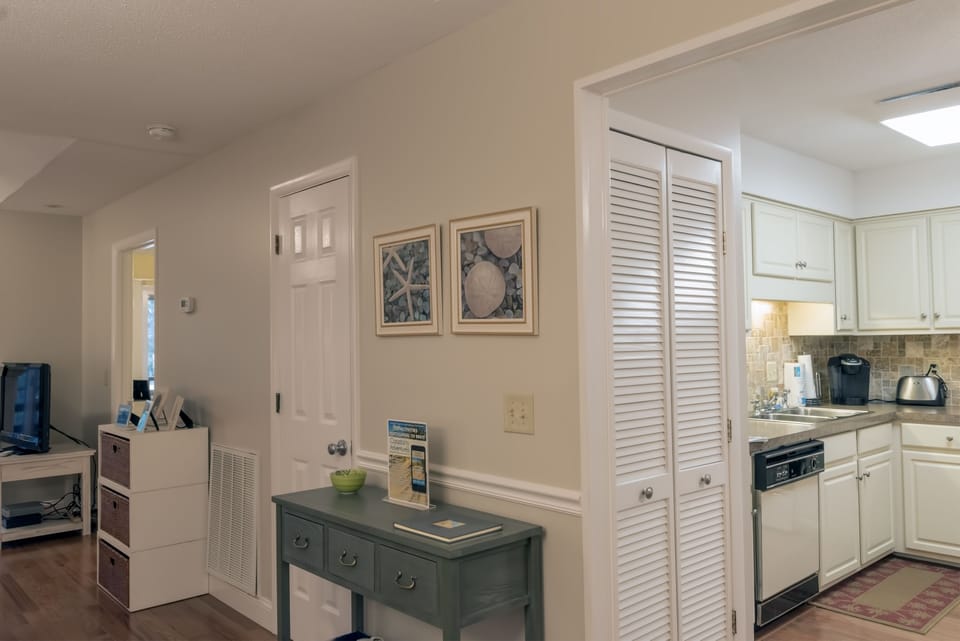There is a stacked washer and dryer behind the doors.
