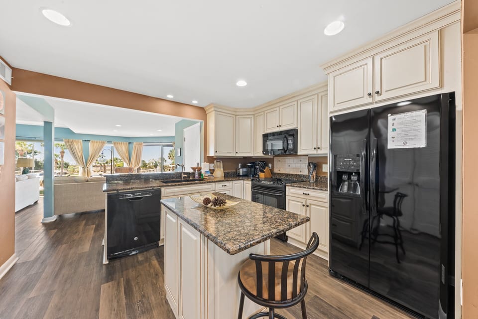 The kitchen features granite counters and a center island.