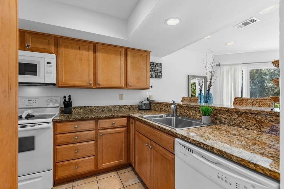 The kitchen has granite counters and is well stocked.