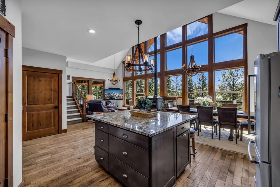 The island serves as the centerpiece of the kitchen, providing ample workspace for meal preparation, casual dining, and socializing