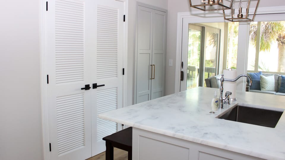 Behind the doors is a pantry. The sliding doors lead to a screened porch.